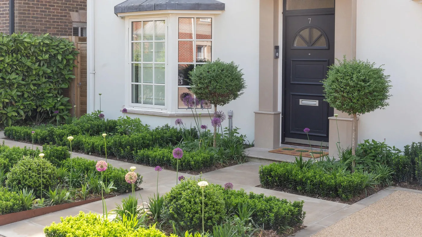 Front garden with stone path, box hedging and alliums