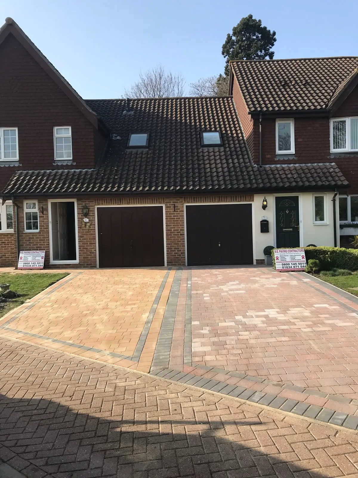 Large paved patio area in a landscaped garden